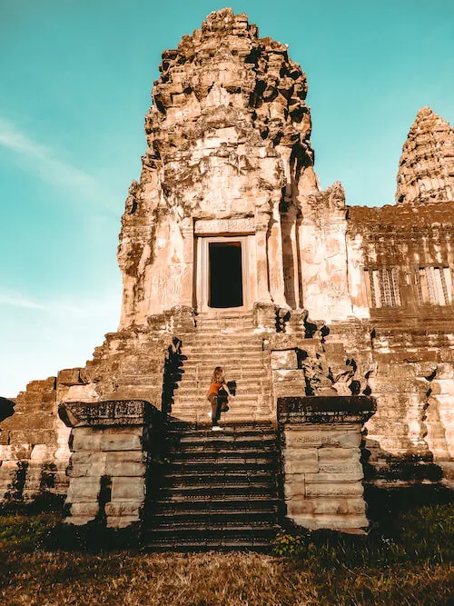 Kat climbing an outer tower of Angkor Wat