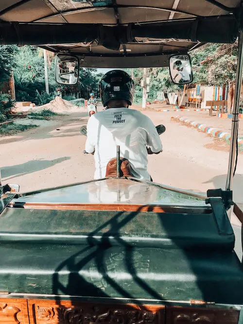 Riding on the back of a tuk tuk