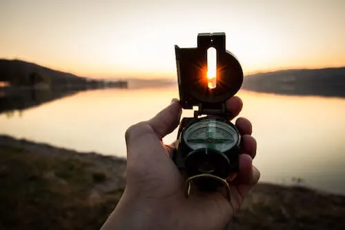 Compass with sunset peaking through