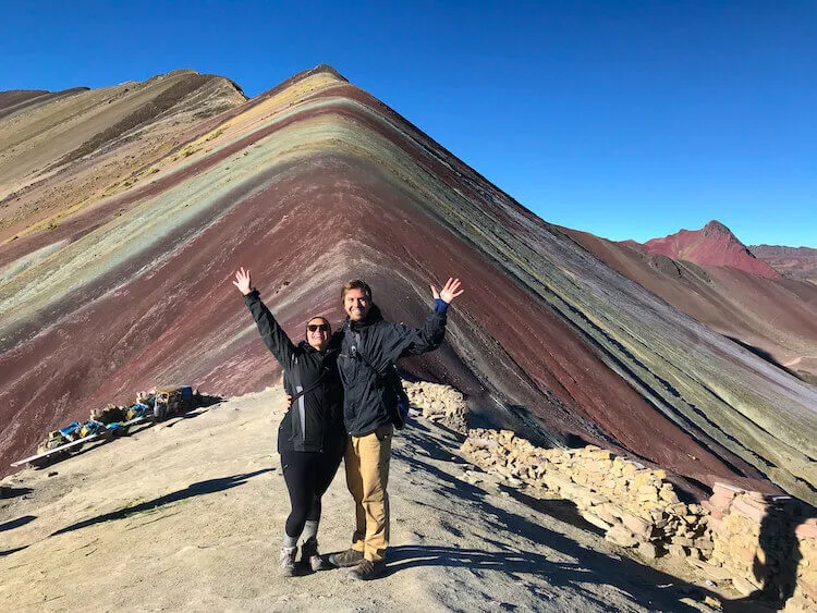 Kat and Chris celebrating in front of Rainbow Mountain, Peru - Peru itinerary