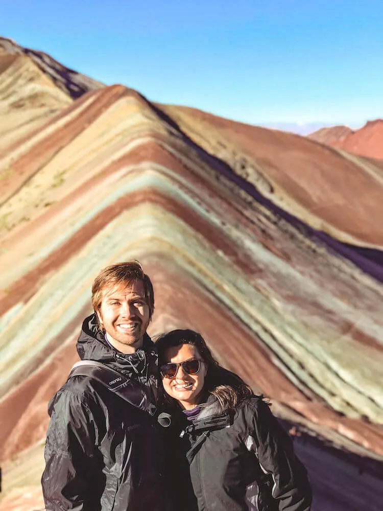 Kat and Chris smiling in front of Rainbow Mountain, Peru - Peru itinerary