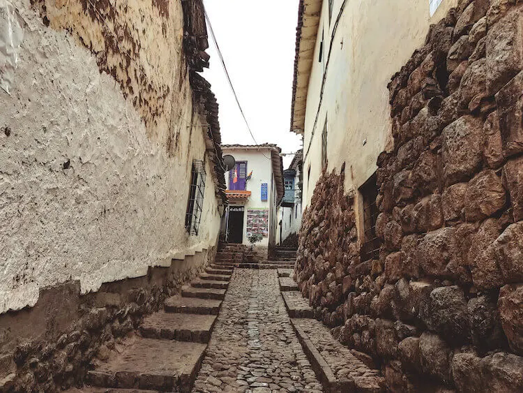 Streets of Cusco with incan stones with housing on top - Peru itinerary