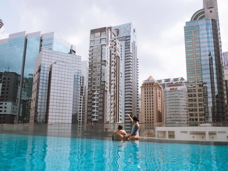 Couple enjoying the city view from a rooftop pool