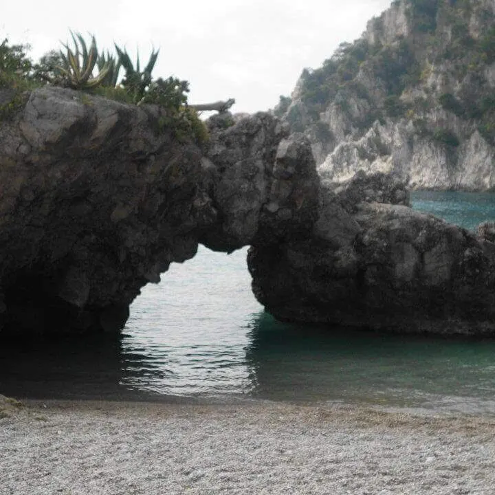 best honeymoon destinations by season: rock arch jutting into Mediterranean sea from Isle of Capri