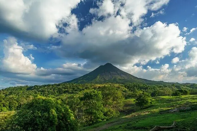 green volcano surrounded by dense forest Costa Rica. Where to honeymoon based on your travel style