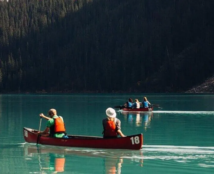 Top 10 Honeymoon Destinations for Adventurous Couples: people kayaking on an azur mountain lake