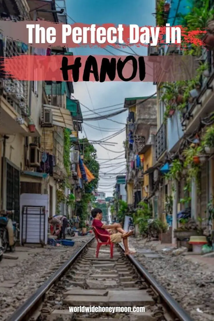 The Perfect Day in Hanoi | Person sitting on the train tracks in a red chair