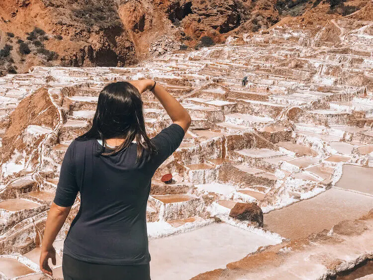 Woman staring off into the distance at the Maras Salt Mines in Peru - Peru itinerary