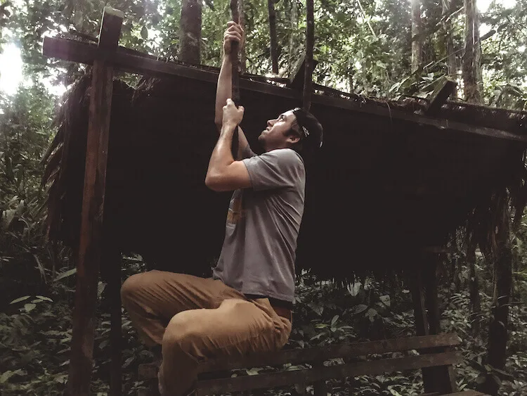 Chris swinging on a vine in the Tambopata National Reserve in the Amazon in Peru - Peru Amazon