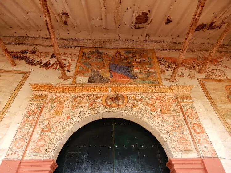 Entrance to Cathedral with intricate paintings in Chinchero, Sacred Valley, Peru