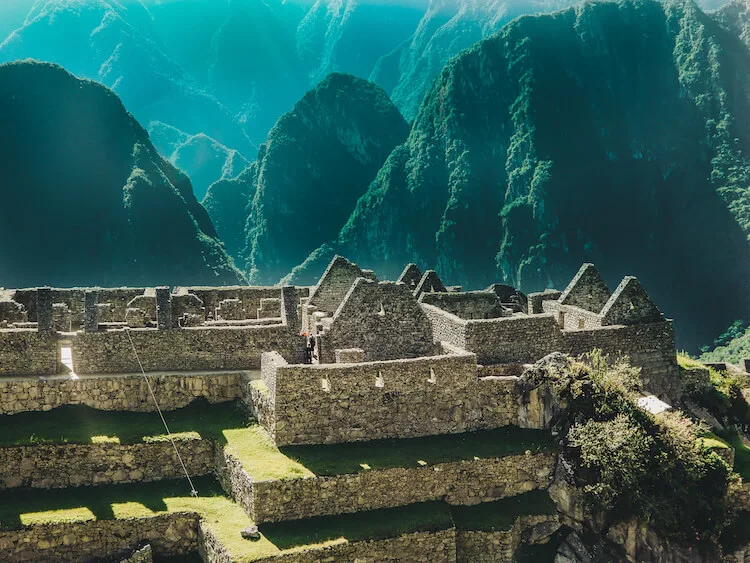 Houses at Machu Picchu with Andes Mountains behind