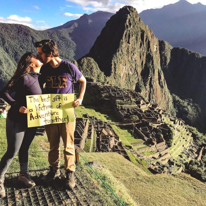 Kat & Chris kissing with sign in front of Machu Picchu: Top 10 Travel Do-Overs