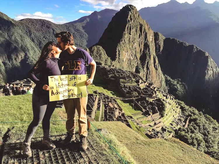 Kat and Chris holding sign at Machu Picchu