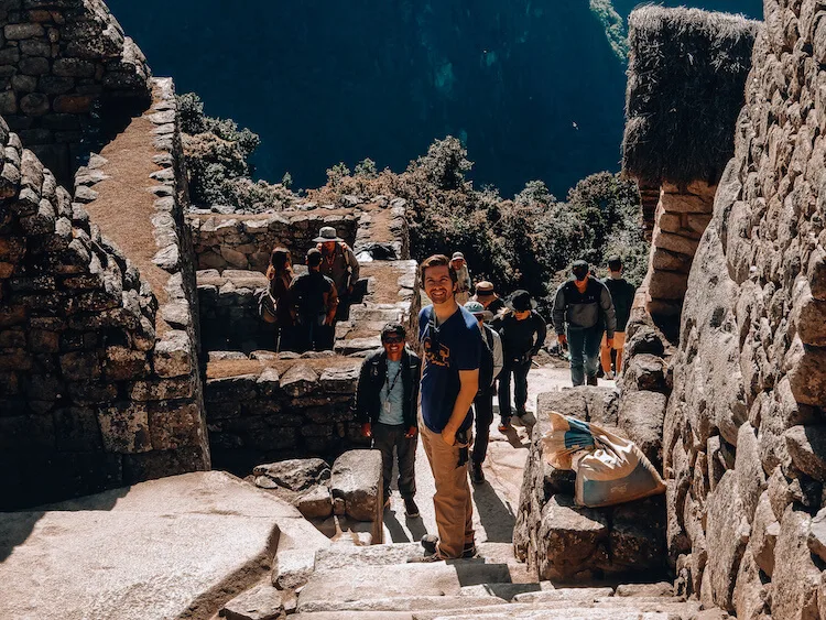 Steep stone stairs at Machu Picchu with Chris and our tour guide, Yeicob