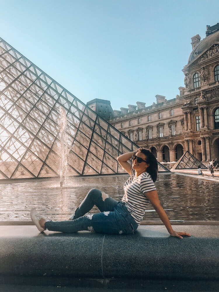 Kat posing in front of the Louvre