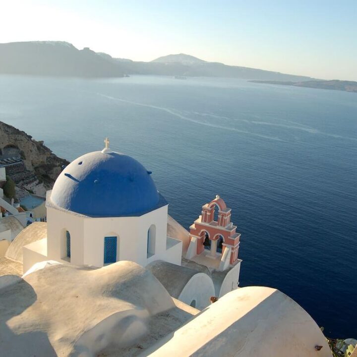 Domed blue churches in Oia, Santorini, Greece during a Perfect Greece Itinerary in 7 Days