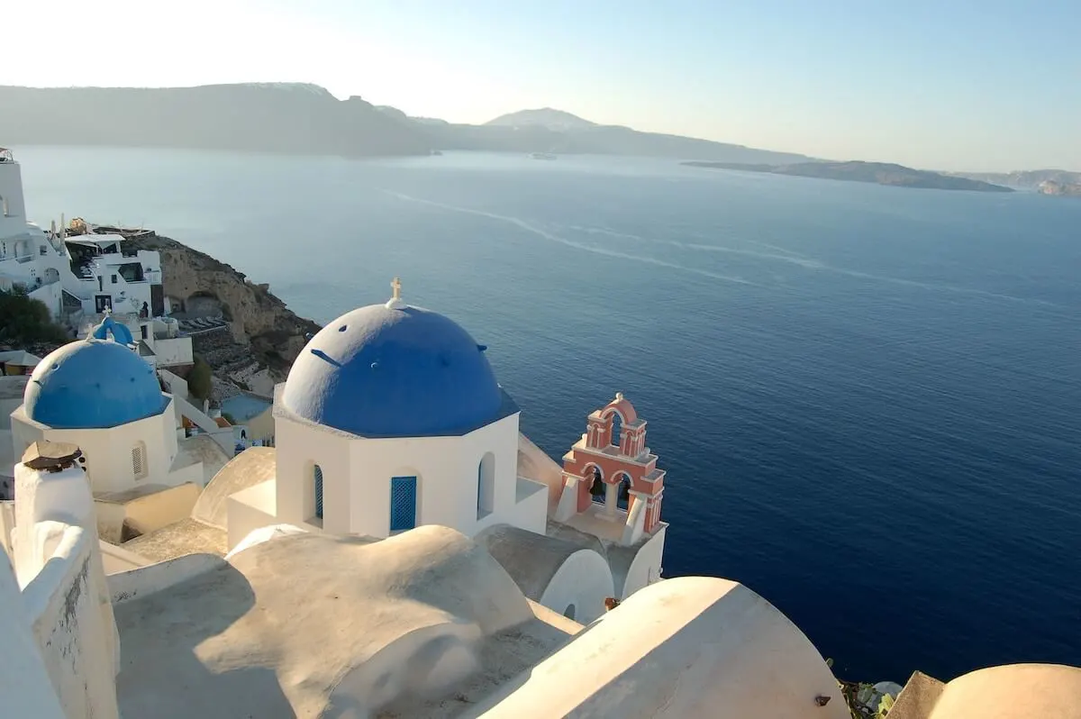 Domed blue churches in Oia, Santorini, Greece during a Perfect Greece Itinerary in 7 Days