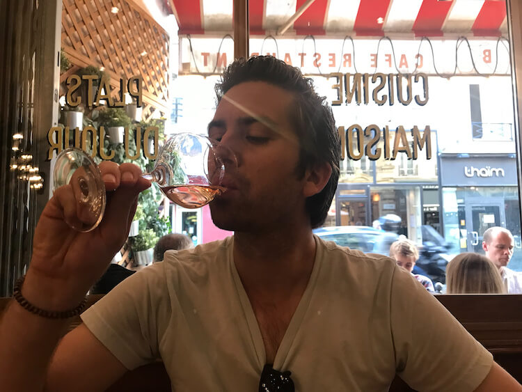 Chris enjoying a glass of rose- Trip to Paris Cost