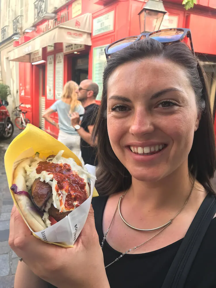 Kat with a falafel in Paris- cheap eats in Paris