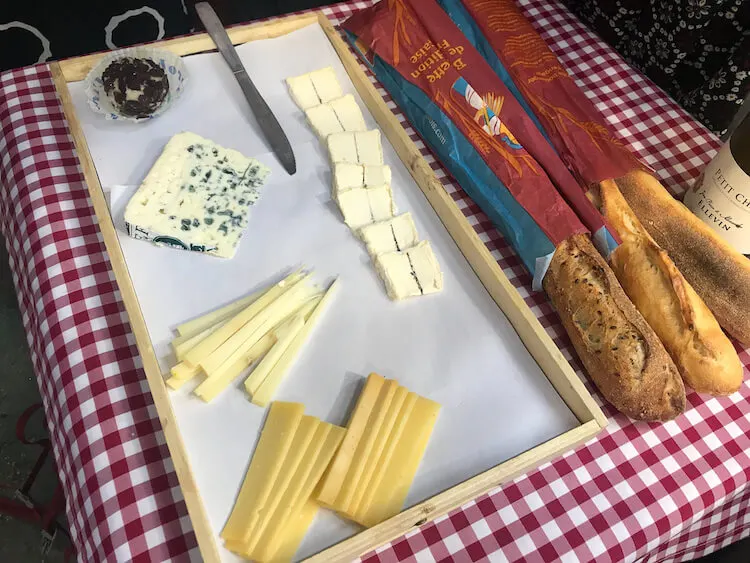 Sampling cheese and baguettes on our Paris Secret Food Tour