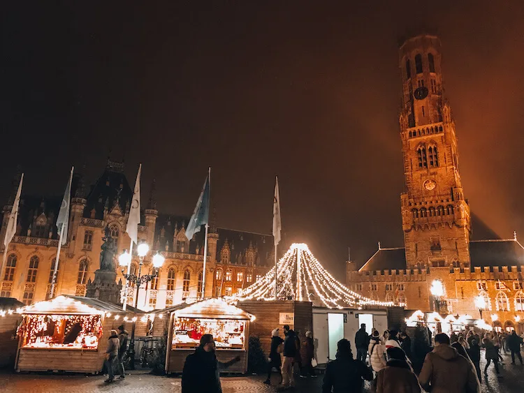 Bruges Christmas market in the Grotemarkt with the Belfry in the background