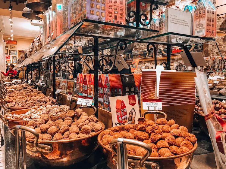 Chocolate pralines in buckets in a Bruges chocolate shop