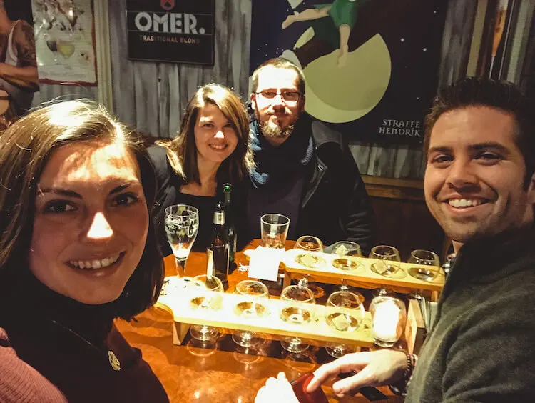 Kat and Chris with their Belgian friends enjoying their beer flights in Antwerp - Where to Drink Beer in Antwerp