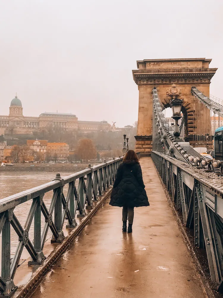 Kat crossing the Chain Bridge on a hazy morning