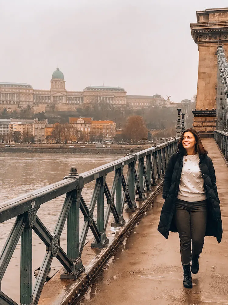 Kat walking in toward the camera on the Chain Bridge in Budapest