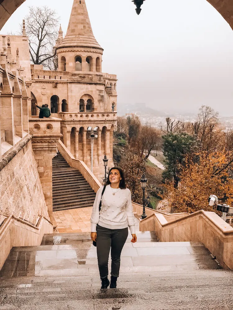 Kat wearing a white pom pom sweater and olive jeans in Budapest - What to wear in Budapest