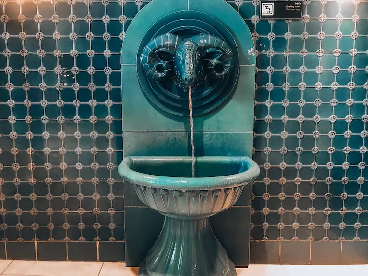Water fountain made from a ceramic ram's head at Rudas Baths