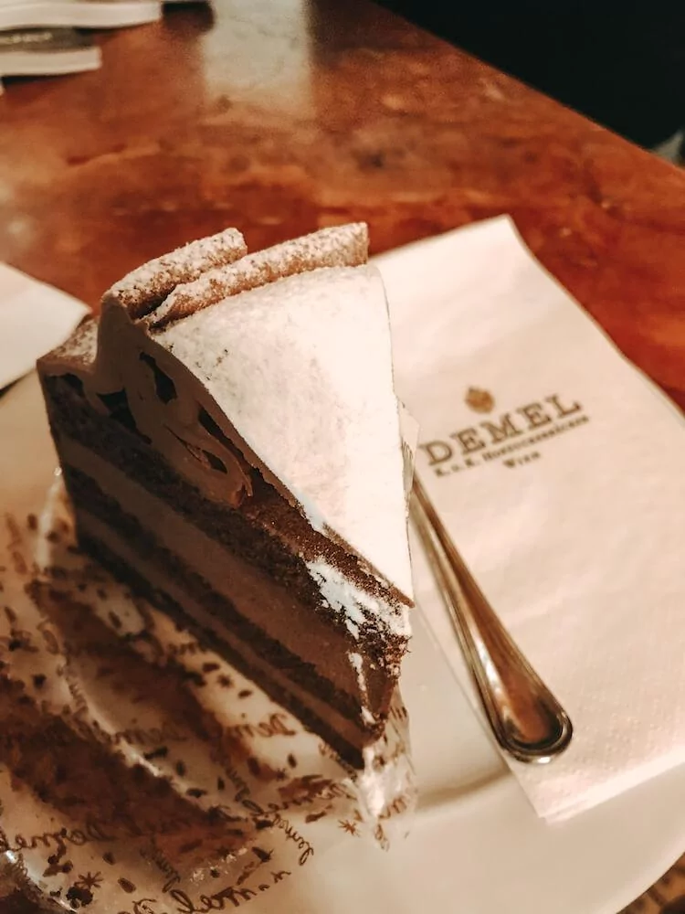 Cafe Demel chocolate hazelnut cake with napkin in Vienna, Austria- Where to Eat in Vienna