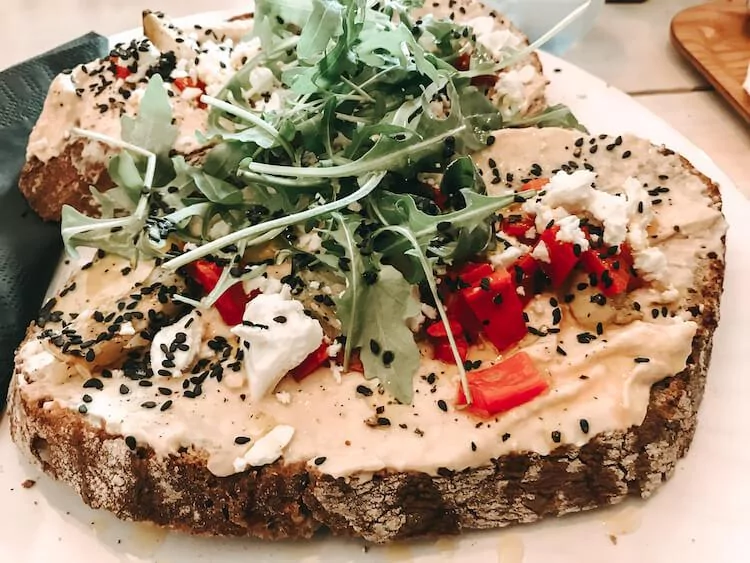 Hummus Toast with arugula, red peppers, and feta and Crumbles and Beans in Antwerp