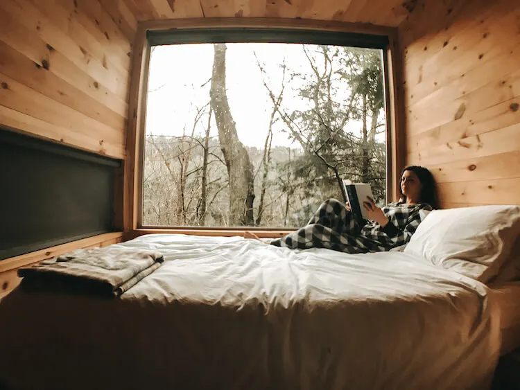 Kat reading in the cabin getaways in Ohio for 2