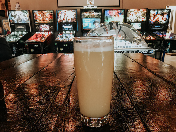 NE IPA in front of old pin ball machines at Birdfish Brewing Company - Getaway House Ohio