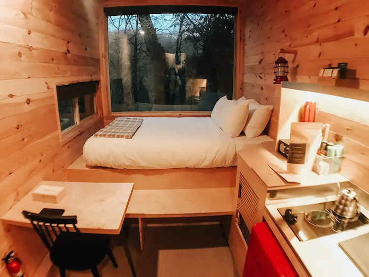 Wide shot of interior of Getaway House Ohio showing bed, table, and kitchen