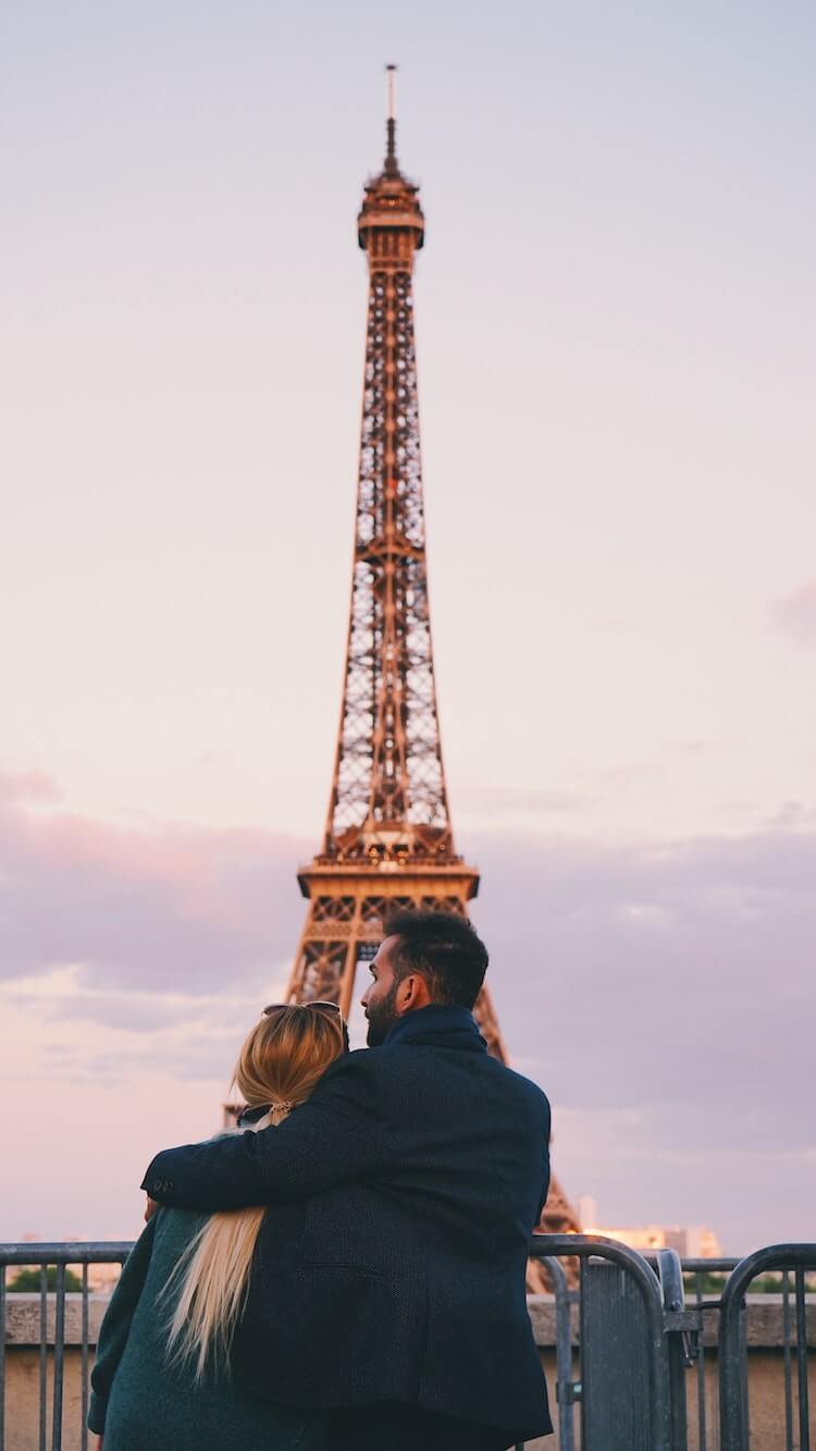 Couple standing in front of the Eiffel Tower