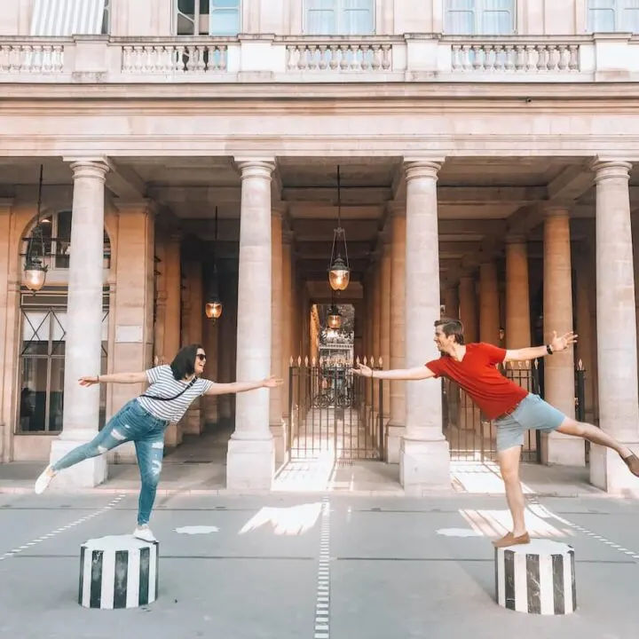 Kat and Chris balancing on cylinders at Palais Royale- What to Wear in Paris
