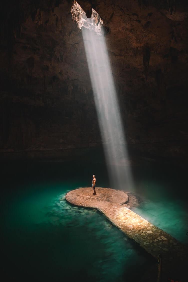 Man in a cenote in Mexico- Bucket List Ideas for Couples Who Love Travel
