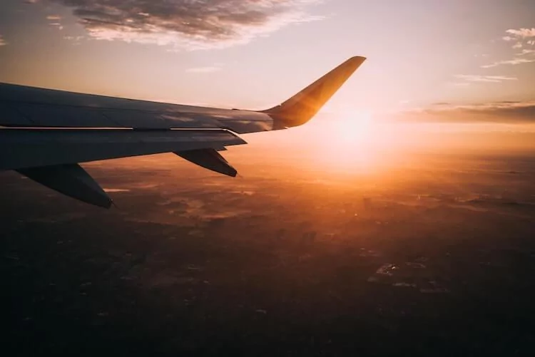 Plane flying around sunset