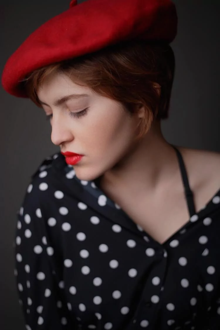 Woman wearing red beret with red lipstick