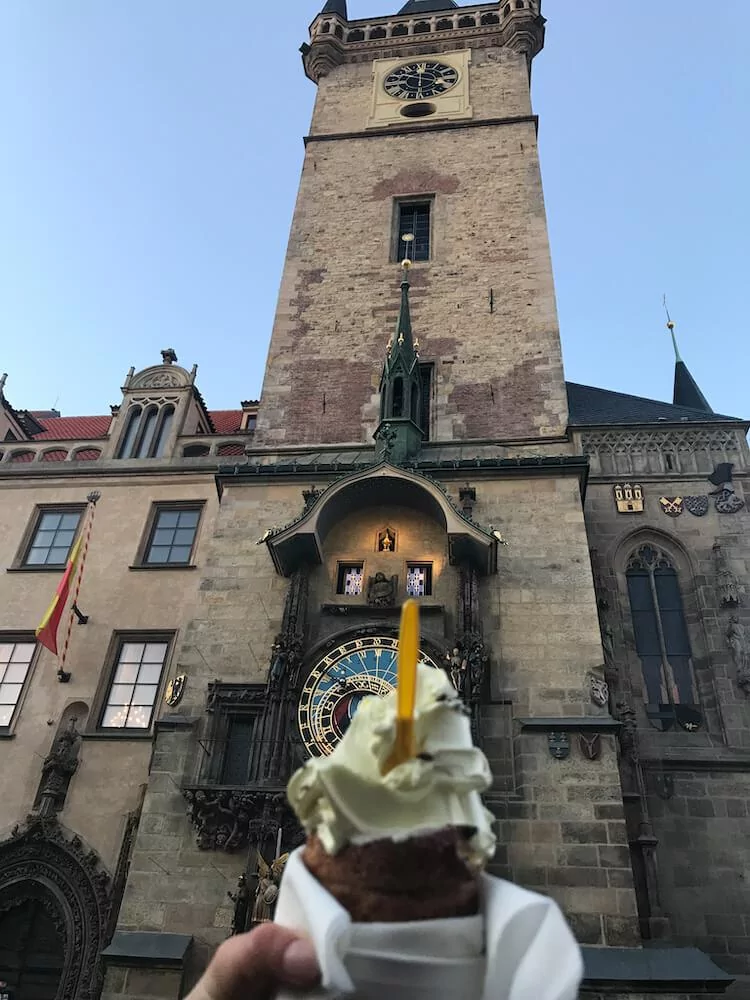 chimney cake in front of Prague Astronomical Clock