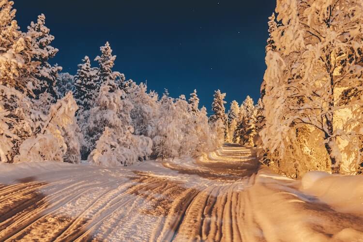 Lapland, Finland at night along a snowmobile trail- Romantic honeymoon destinations in Europe