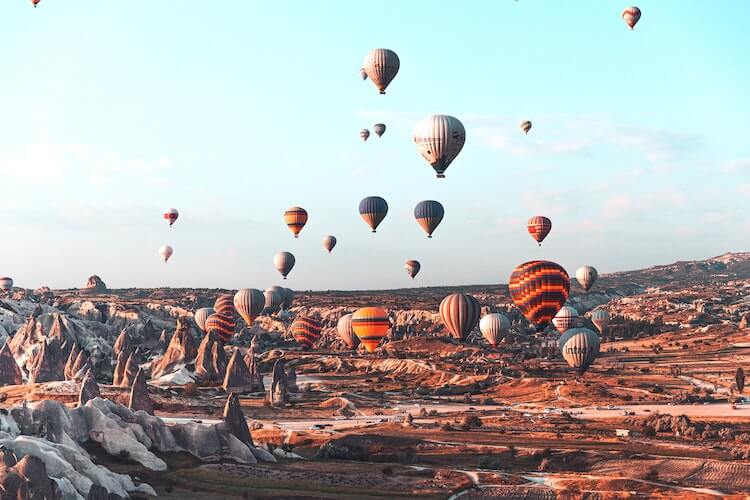 Sunrise hot air balloons over the caves in Cappadocia