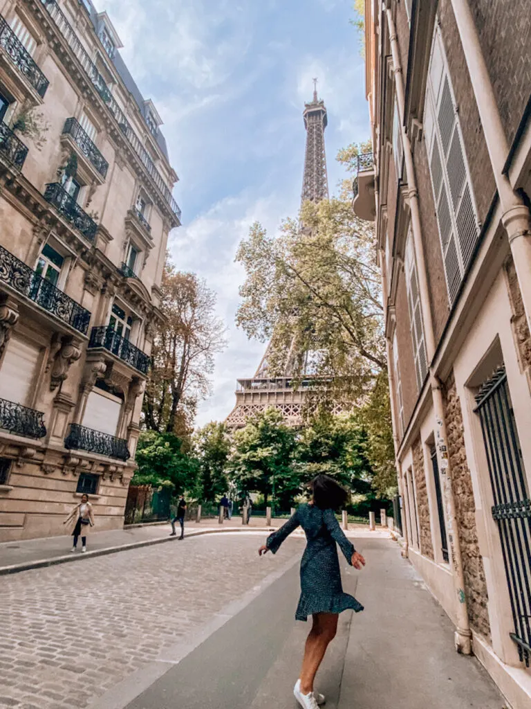 Kat spinning on a street with the Eiffel Tower in the background