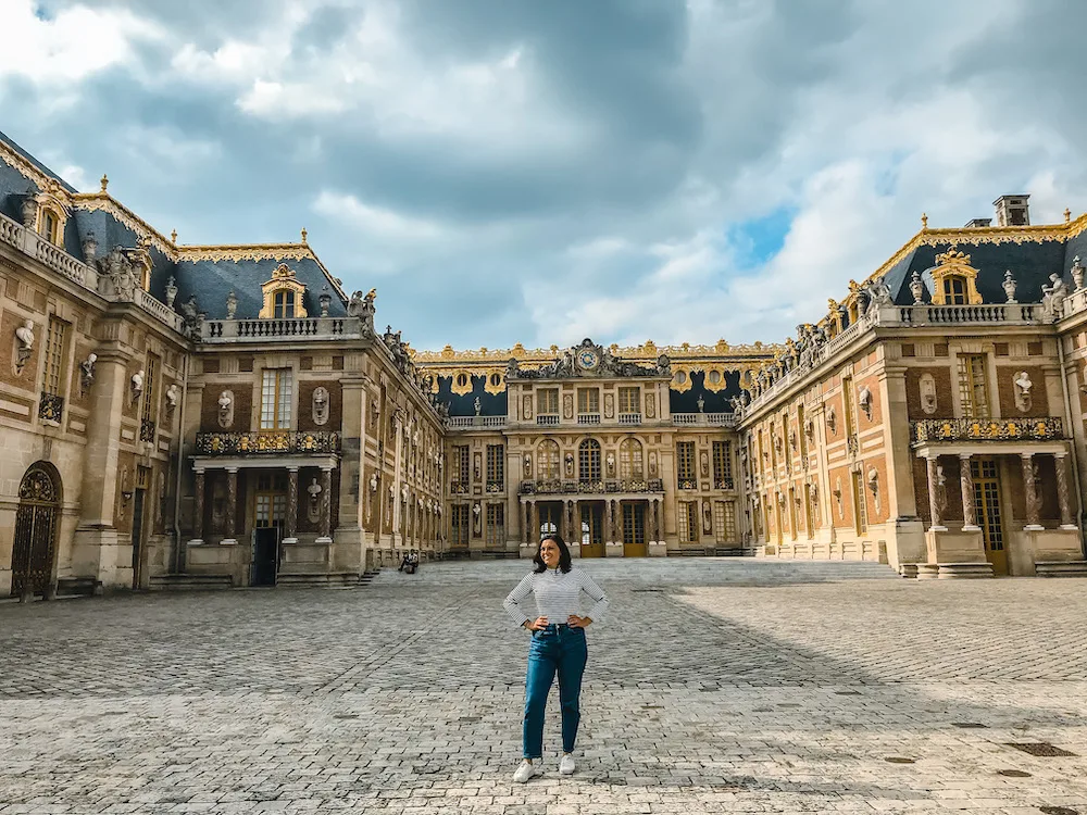 Kat standing in front of Versailles | What to Wear in Paris