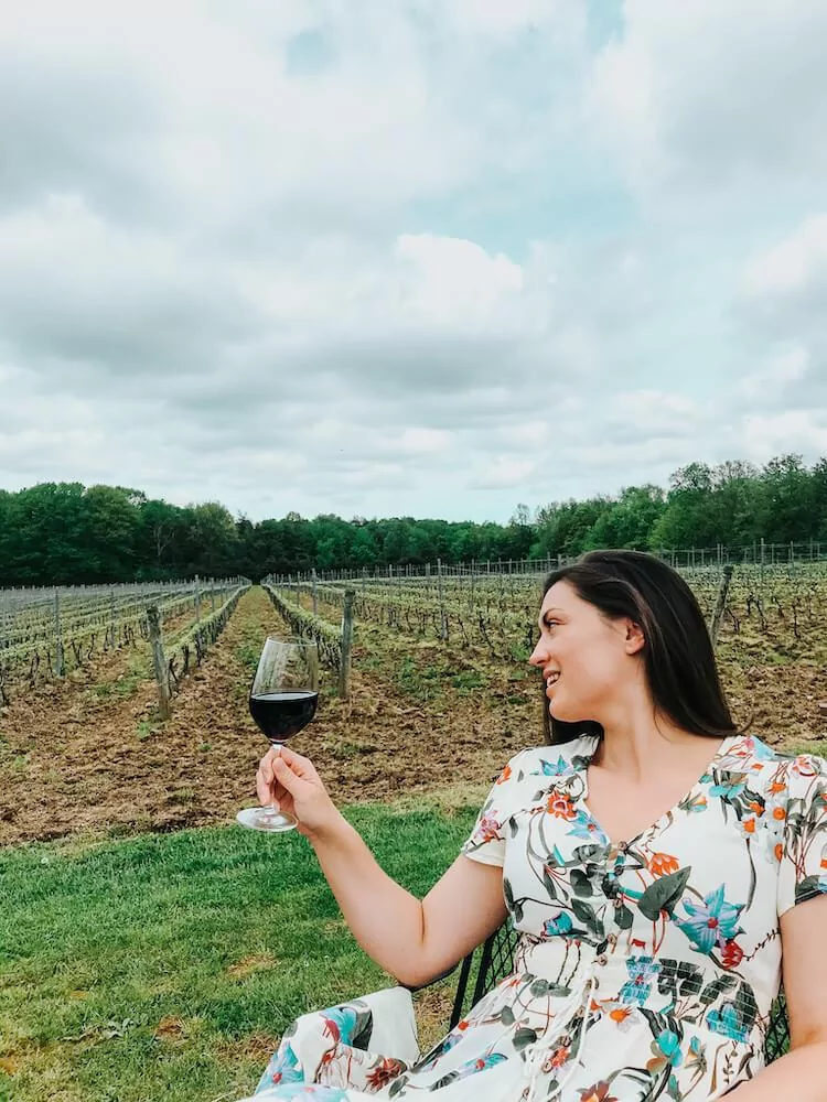 Kat looking at her glass of Meritage During a Ohio Winery Getaway