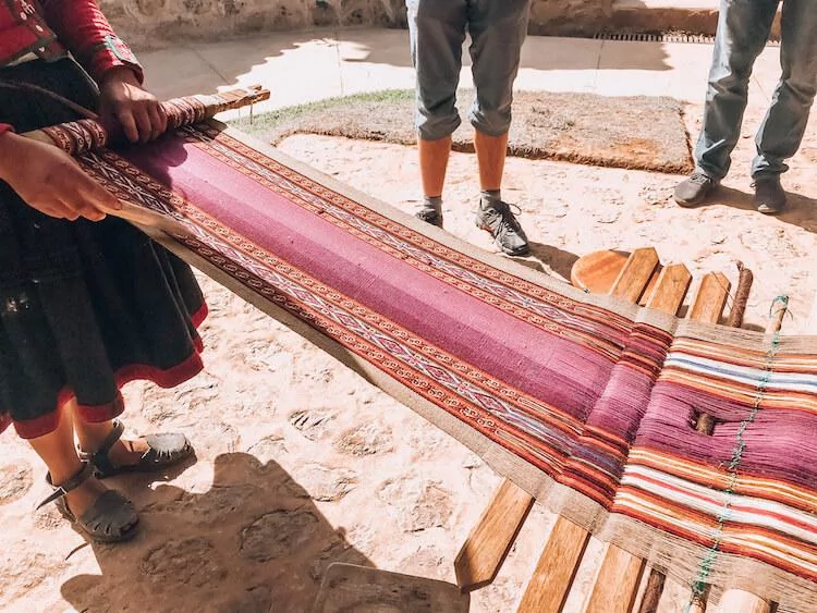 Peruvian local making a handmade Peruvian souvenir of an alpaca table runner