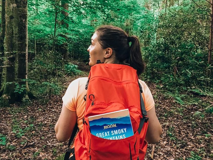 Kat close up hiking in the Great Smoky Mountains National Park with the Moon Travel Guide