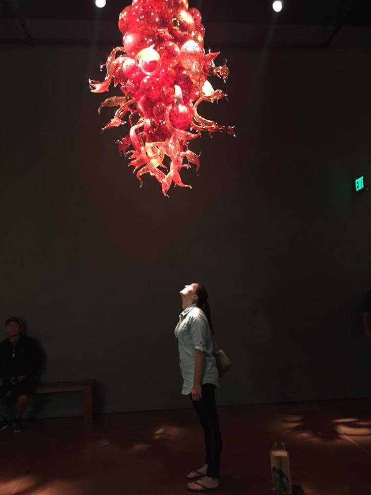 Kat standing under a peice by Chihuly